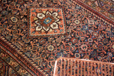 Engelas diamond medallion and Herati field with brick red, navy, ivory, turquoise.