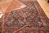 Softened allover garrus and arabesque patterns in cherry red and navy on vintage Mahal rug.