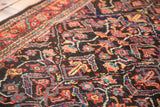 Intricate garrus and tiny animal motifs on vintage Mahal rug in dark navy, red, teal.