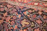 Detail of intricate garrus and tiny animal motifs on dark navy Mahal field.