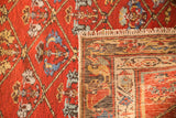 Hand-knotted foundation and fringe details of a fine Hamadan rug, cherry red floral lattice.