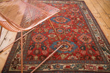 Antique Harshang Bijar rug's cherry red ground, garrus arabesques, and detailed European border.