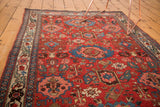 Intricate garrus arabesques and classic Persian motifs on the cherry red ground of an antique Bijar rug.