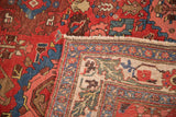 Corner of antique Harshang Bijar rug, cherry red field and dramatic European-style border.