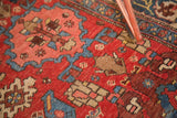 Diminutive garrus arabesques and motifs on the cherry red Harshang Bijar rug pile.