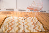 Vintage Southwestern Navajo rug showing serrated raw gold, ivory, beige, caramel pattern.
