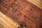 Antique Anatolian runner's geometric pattern in bold red, purple, and teal natural dyes.