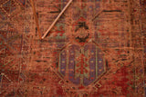 Antique Anatolian rug's natural dyed red field, geometric purple, teal motifs, and textural restoration.