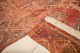 Antique Anatolian rug's visible backing, contrasting its hand-knotted red, blue, and teal patterns.