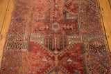Hand knotted antique Anatolian runner shows geometric motif in bold red, purple, teal.