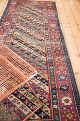 Vibrant diagonal stripes, growing plant motifs, and patterned floral border on this antique Caucasian runner.