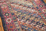 Vibrant geometric plant motifs, diagonal stripes, and distressed pile on an antique Caucasian runner.
