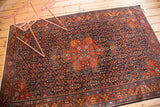 Finely woven Farahan Sarouk rug with intricate brick red medallion and navy field motifs.