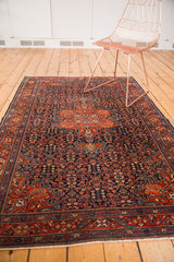 Finely woven vintage Farahan Sarouk rug corner, with intricate henna plant motifs and fringe.