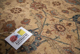 Textured detail of Tabriz rug's beige, blue, brown Veramin floral and palmette design.