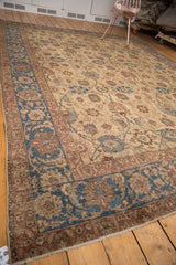 Vintage Tabriz corner showing Veramin floral motifs, blue border, and natural distress.