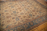 Curvilinear blue border with floral palmettes and beige field on this vintage Tabriz carpet.