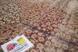 Antique Kerman panel carpet with cochineal red millefleur within navy blue scalloped motifs.