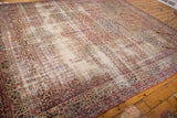 Traditional Kerman panel carpet in cochineal red and navy blue with age-worn texture.