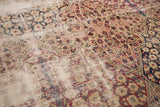 Patina on antique Kerman carpet, showing beige foundation and softened floral motifs.