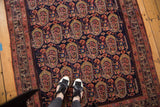 Vintage Malayer rug's repeating floral boteh motifs in blush, ivory, and bronze tones.