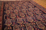 Detailed view of vintage Persian Malayer rug's navy field with blush, bronze floral botehs.