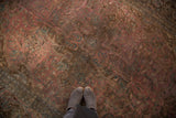 Vintage Meshed carpet's blush raspberry floral field with faded teal and brown patterns.