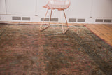 Vintage Meshed carpet's blush floral field, deep brown, and teal motifs.