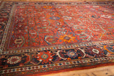 Vintage Persian Mahal rug corner detail: rust red field, delicate vinery, palmettes, blue border.