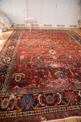 Vintage Persian Mahal rug's rust red field, delicate vinery, palmettes, and patterned border.