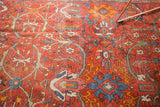 Vintage Mahal carpet detail with vinery and splayed floral motifs in rust, blue, and orange.