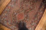 Southwest Persian Qashqai rug displaying central madder red medallion, blue tones, and animal motifs.