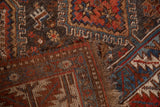 Worn edge and foundation weave of the hand-knotted Qashqai rug, revealing geometric patterns.