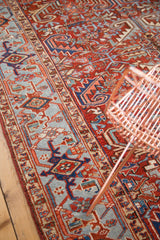 Vintage Heriz rug border featuring brilliant light blue geometric patterns on cherry red.