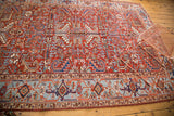 Geometric border of the vintage Heriz rug with sky blue, navy, and tangerine motifs.
