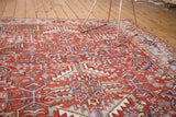 Vintage Heriz carpet's intricate allover geometric pattern in cherry red and blue.