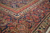 Tight weave of antique Mahal rug corner, featuring intricate Herati motif in madder red, navy, camel.