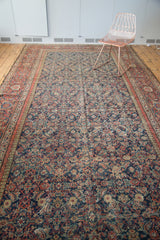 Intricate Herati motif with navy, madder root red, and saffron tones on the antique Mahal rug.