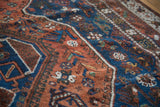 Vintage Qashqai carpet detail showcasing madder root red, deep blue tribal designs.