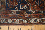 Vintage Qashqai rug lower border, woven bird motifs on cream, madder red, and blue tones.