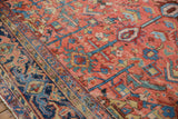 Vibrant blush, sky blue, and navy geometric floral patterns on a vintage Heriz rug.