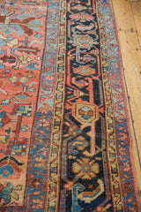 Traditional geometric floral patterns in blush, sky blue, and navy on a vintage Heriz carpet.