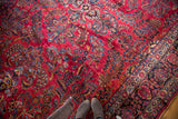 Vintage American Sarouk rug, raspberry red floral field and navy lotus palmette border.