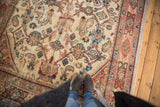 Hand-knotted vintage Mahal rug featuring primitive Herati motif, worn pile, and ivory, rust tones.