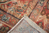 Hand-knotted vintage Mahal rug corner, showing rustic Herati motif pile and light blue foundation.