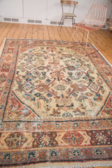 Worn ivory field, primitive Herati motifs, and rust-terra cotta border on a vintage Mahal rug.