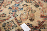 Close-up vintage Mahal rug pile with primitive Herati motif in ivory, rust, and blue.