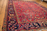 Vintage Mehrivan Heriz carpet's dark navy geometric border and serrated leaf cherry red field.