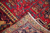Vintage Mehrivan Heriz rug's folded corner, showing hand-knotted back and intricate cherry red pile.