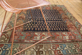 Antique Hamadan rug featuring a navy boteh field and colorful scrolling arabesque borders.